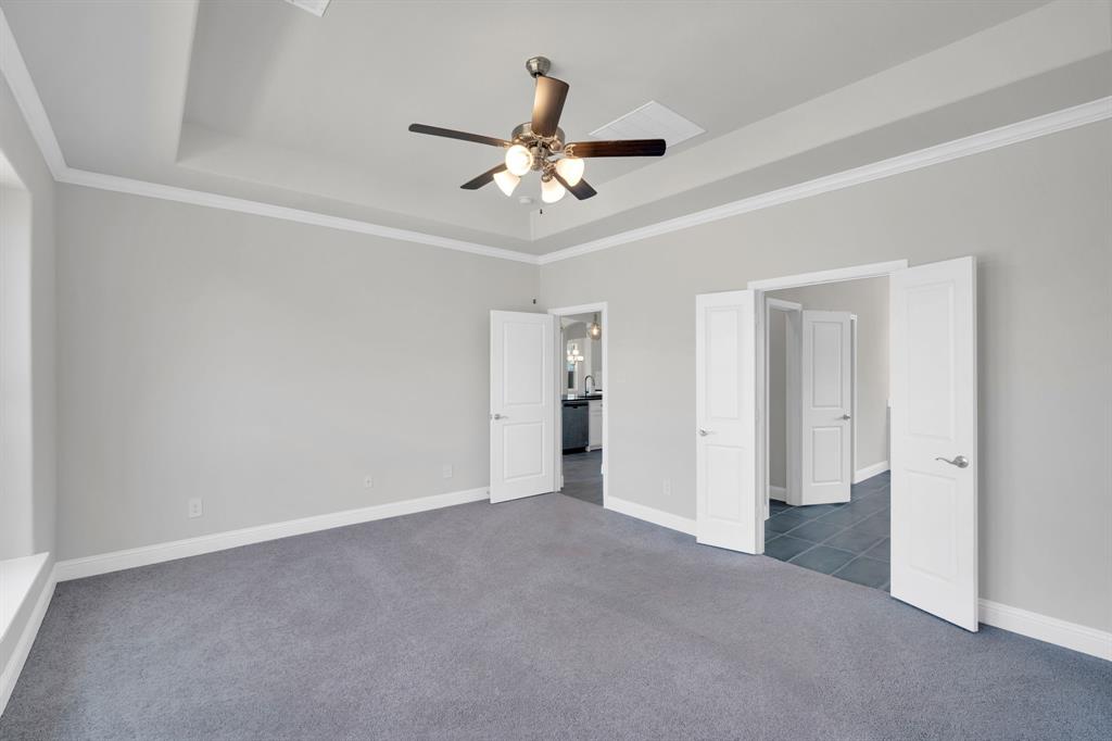 395 Haven Road Waxahachie, TX 75165 - Photo 15 of 40 Primary bedroom with carpet, a tray ceiling, ceiling fan, and crown molding