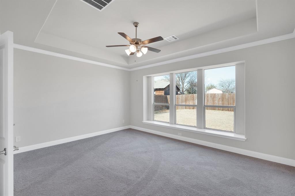 395 Haven Road Waxahachie, TX 75165 - Photo 17 of 40 an empty room with chandelier fan and windows