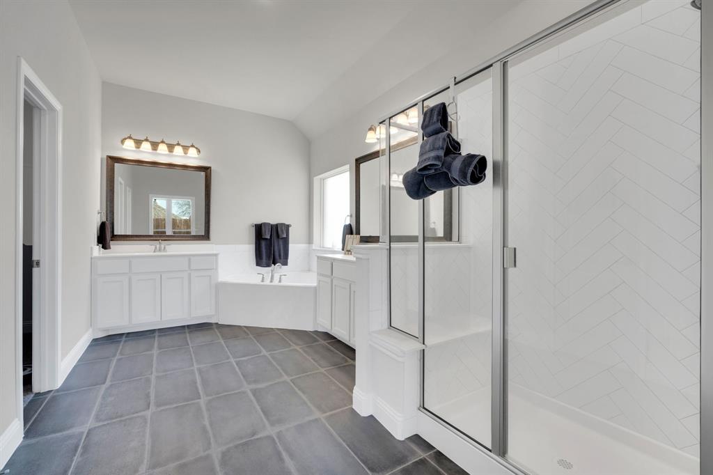 395 Haven Road Waxahachie, TX 75165 - Photo 19 of 40 Bathroom featuring a stall shower, lofted ceiling, vanity, dark tile patterned flooring, and a garden tub