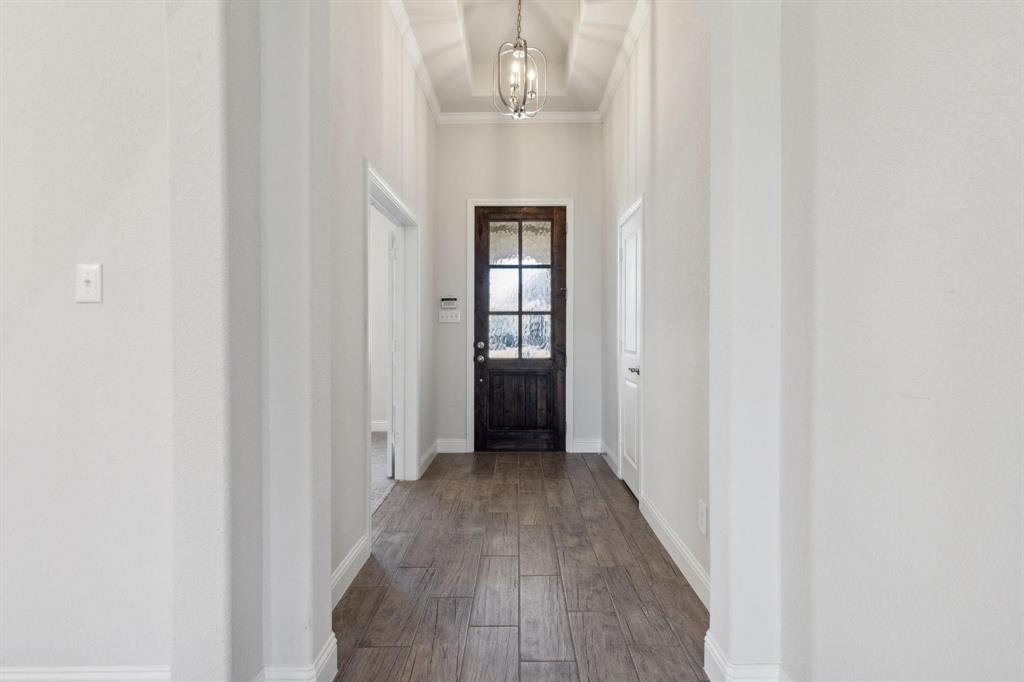 395 Haven Road Waxahachie, TX 75165 - Photo 3 of 40 a view of a hallway with wooden floor and staircase