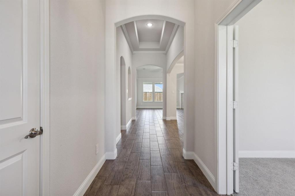395 Haven Road Waxahachie, TX 75165 - Photo 4 of 40 a view of a hallway with wooden floor