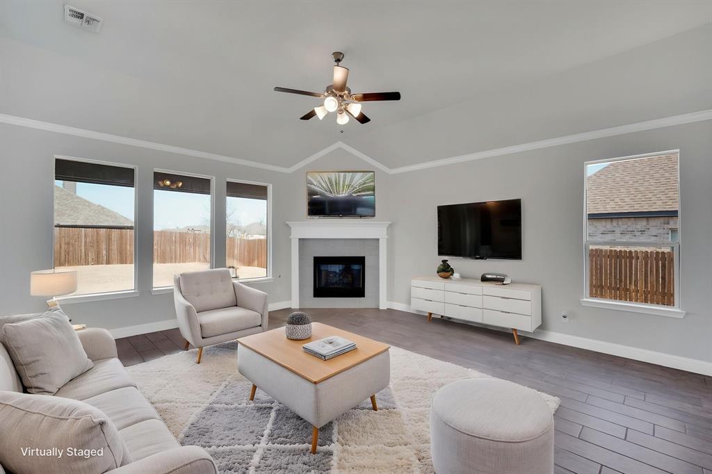 395 Haven Road Waxahachie, TX 75165 - Photo 6 of 40 a living room with furniture a flat screen tv and a fireplace