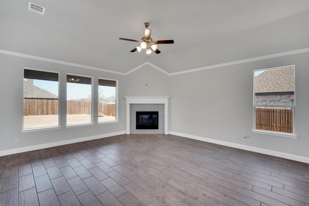 395 Haven Road Waxahachie, TX 75165 - Photo 7 of 40 a view of an empty room with a window and fireplace