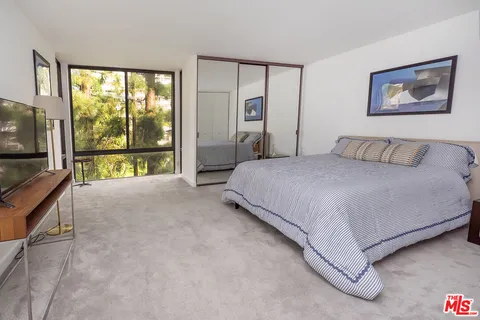 a spacious bedroom with a bed and a table in it