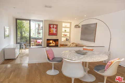 a kitchen with furniture and a wooden floor