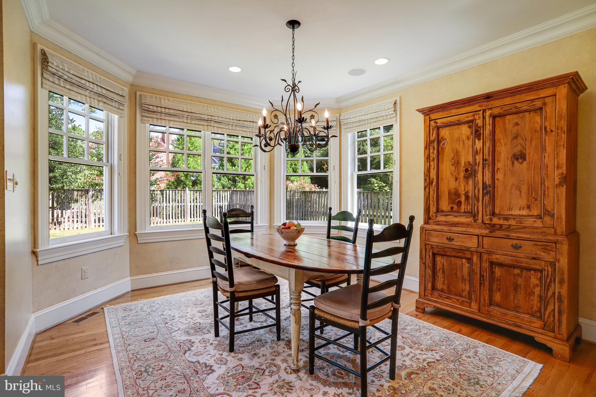 5629 Newington Road Bethesda, MD 20816 - Photo 14 of 65 a dining room with furniture a chandelier and wooden floor