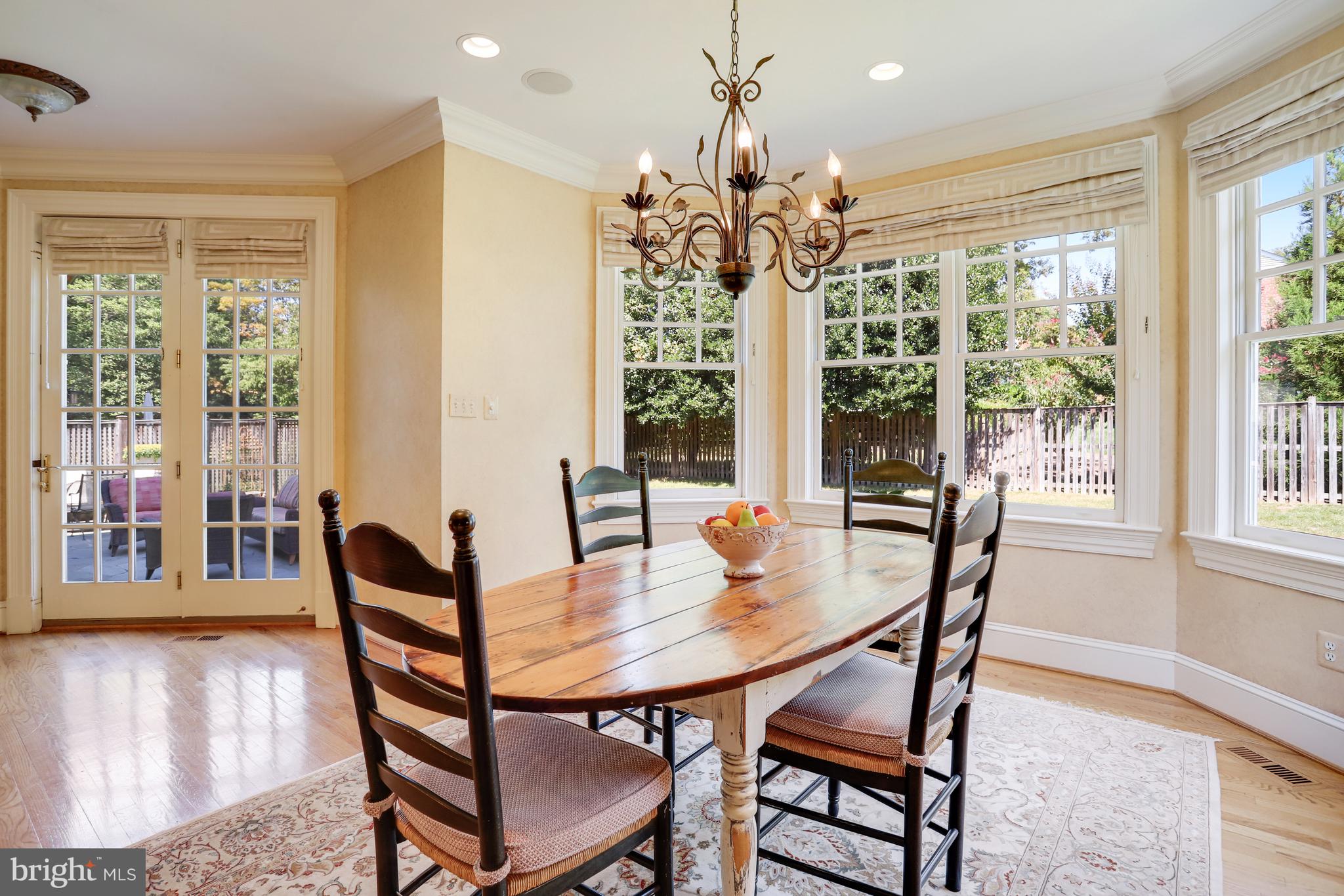 5629 Newington Road Bethesda, MD 20816 - Photo 17 of 65 a view of a dining room with furniture wooden floor and chandelier