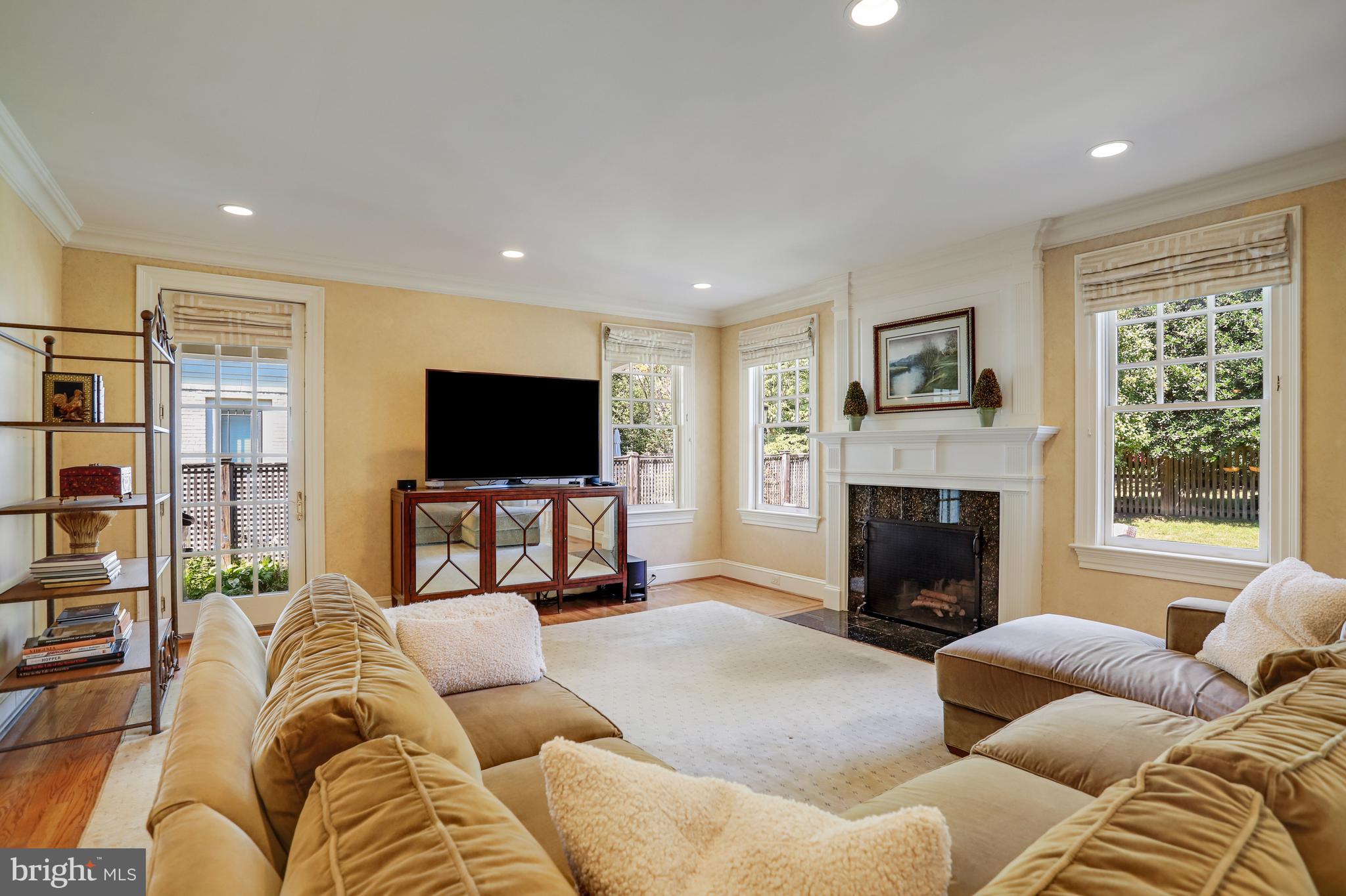 5629 Newington Road Bethesda, MD 20816 - Photo 20 of 65 a living room with furniture and a flat screen tv