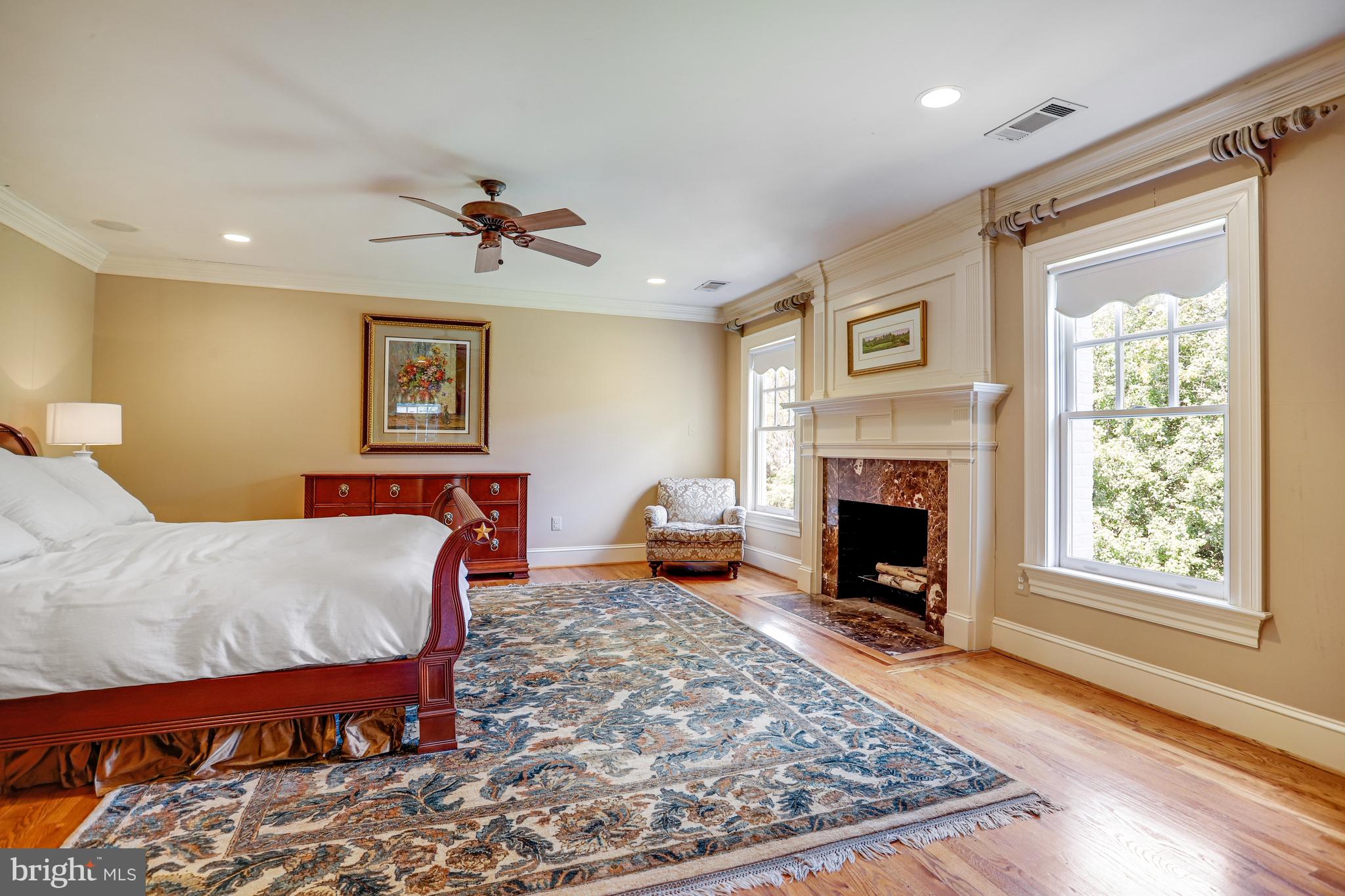 5629 Newington Road Bethesda, MD 20816 - Photo 26 of 65 a bed room with a bed and a fireplace