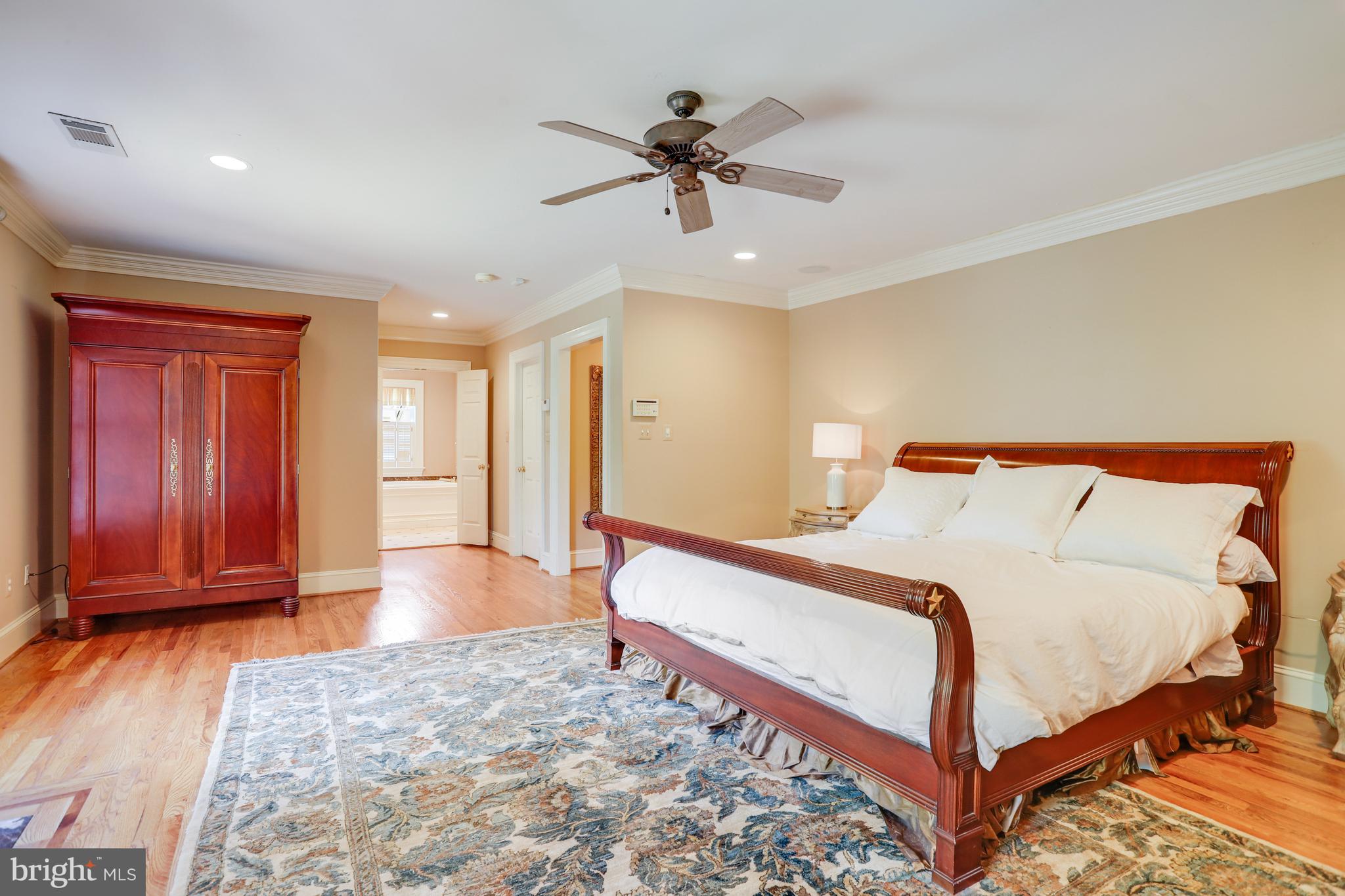 5629 Newington Road Bethesda, MD 20816 - Photo 28 of 65 a bed room with a bed and a chandelier