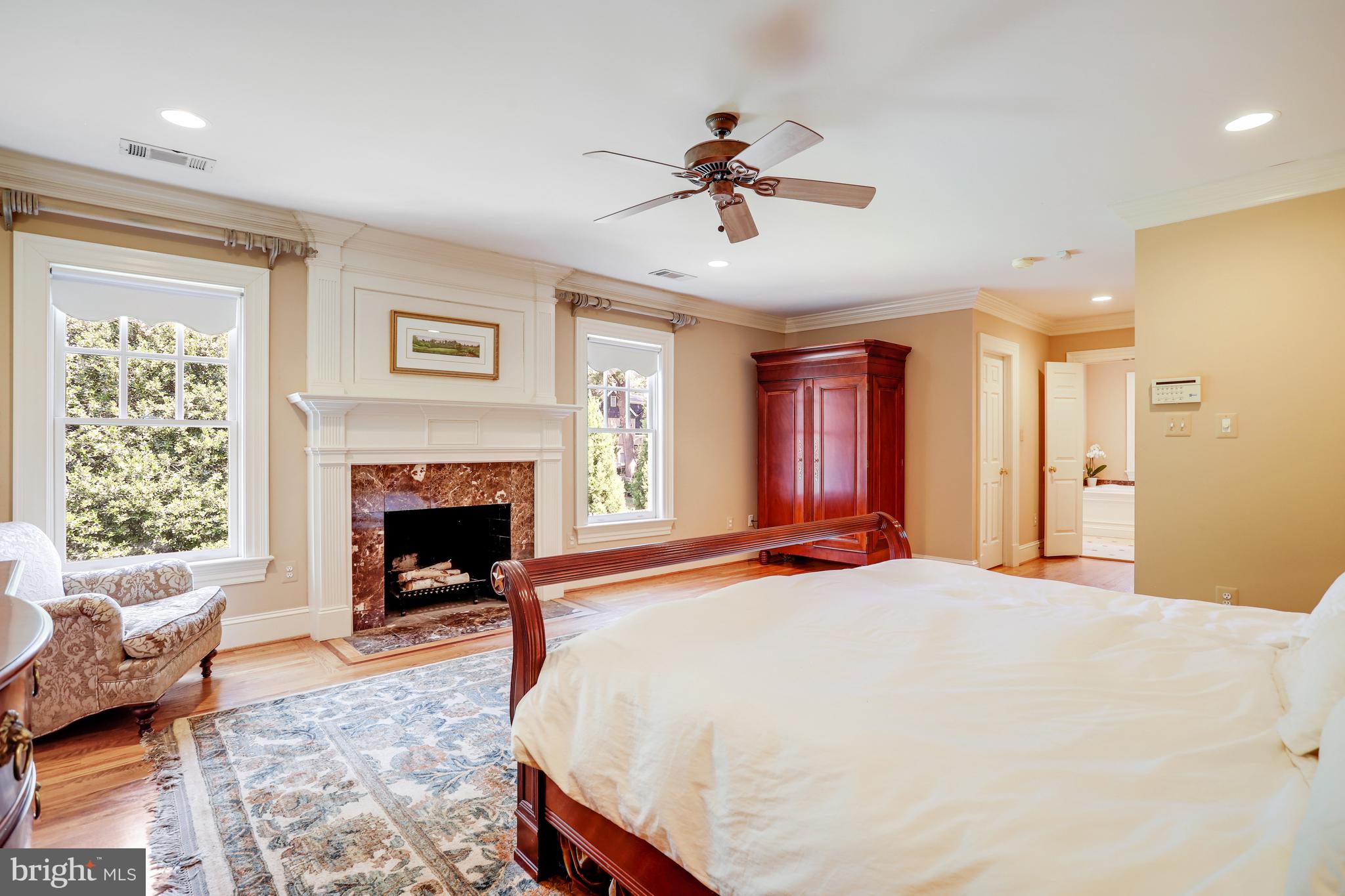 5629 Newington Road Bethesda, MD 20816 - Photo 29 of 65 a bed room with a bed and a fireplace