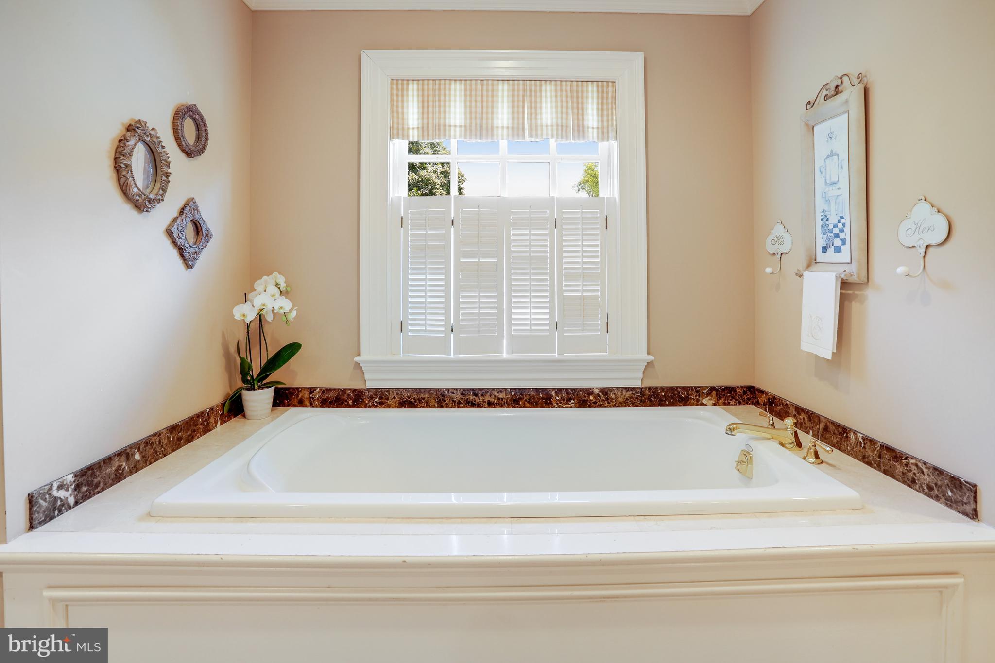 5629 Newington Road Bethesda, MD 20816 - Photo 30 of 65 a white bath tub sitting next to a window