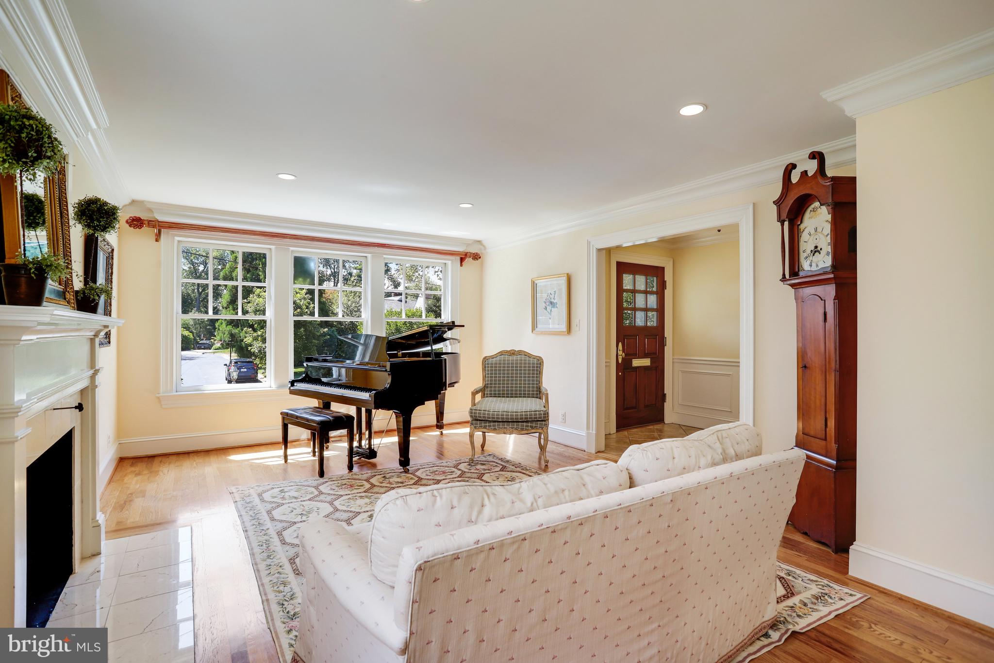 5629 Newington Road Bethesda, MD 20816 - Photo 3 of 65 a living room with furniture a fireplace and a large window