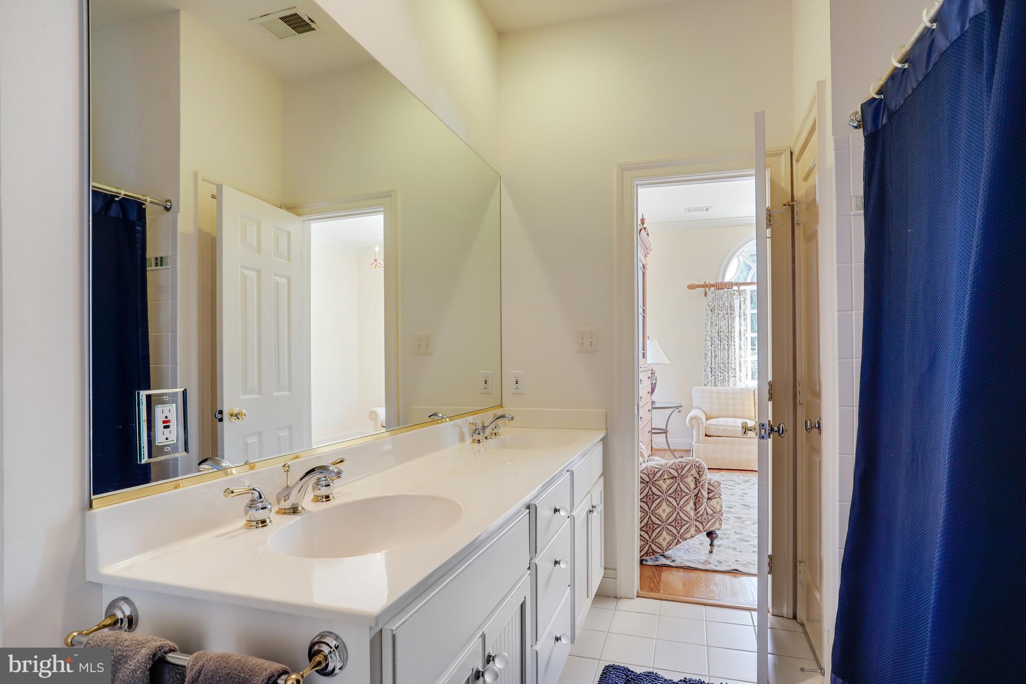 5629 Newington Road Bethesda, MD 20816 - Photo 36 of 65 a bathroom with a sink and a mirror