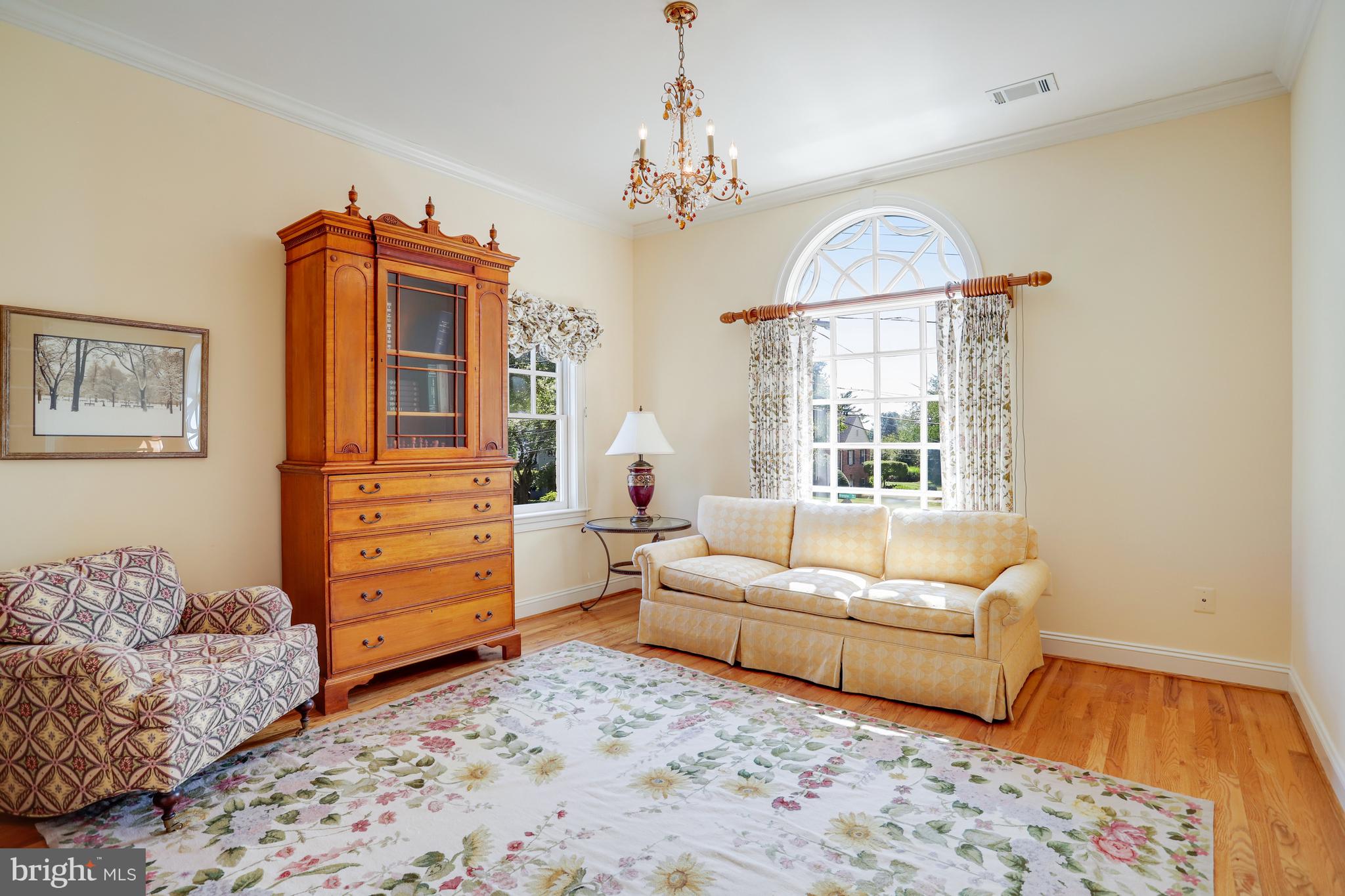 5629 Newington Road Bethesda, MD 20816 - Photo 39 of 65 a living room with furniture and a chandelier