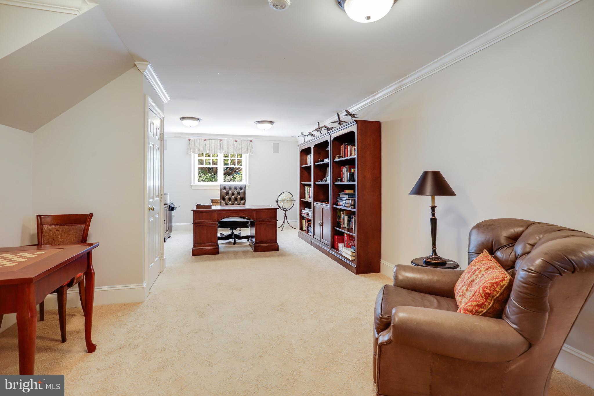 5629 Newington Road Bethesda, MD 20816 - Photo 47 of 65 a living room with furniture and a book shelf