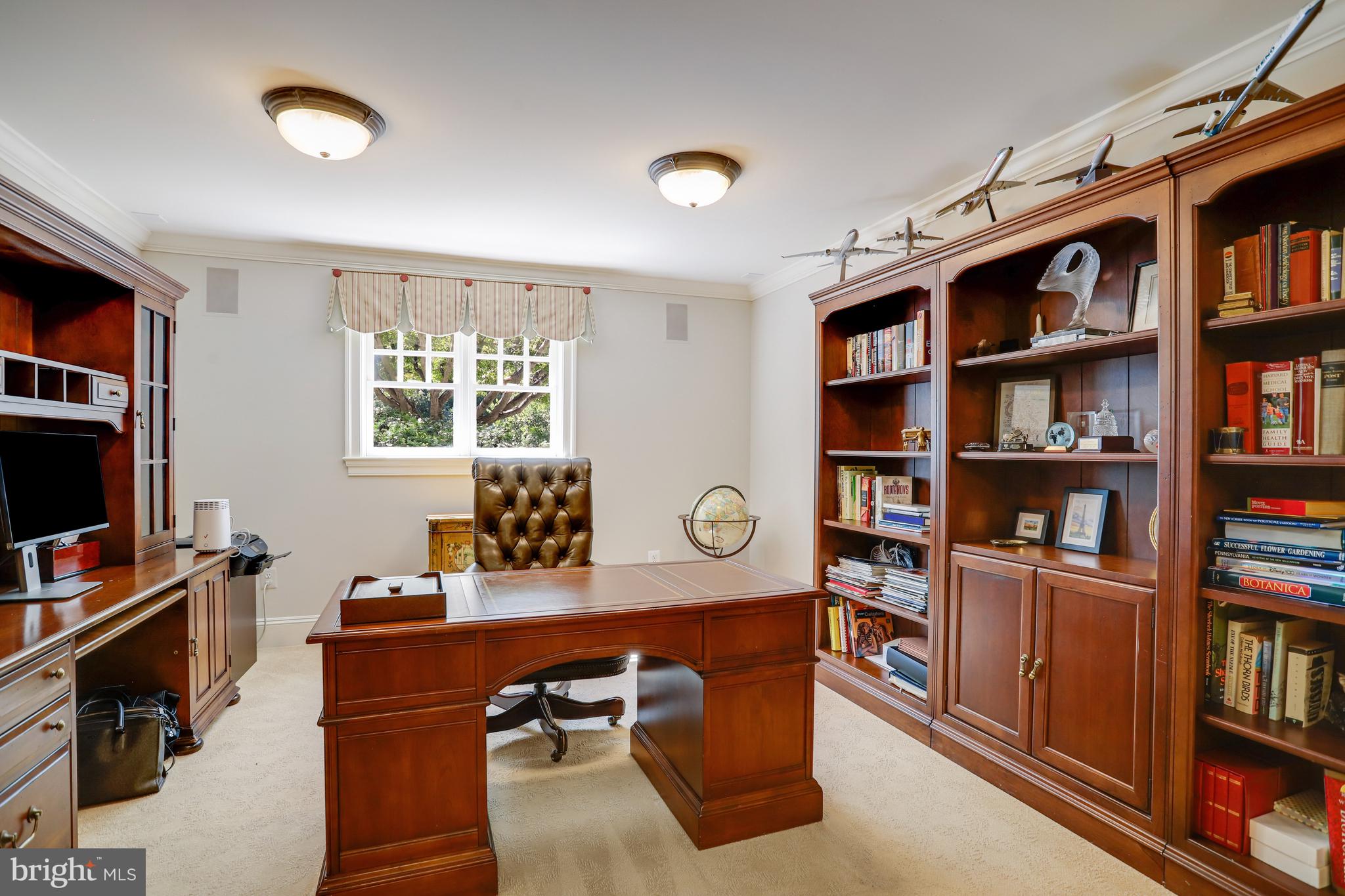 5629 Newington Road Bethesda, MD 20816 - Photo 48 of 65 a view of a workspace with furniture and a bookshelf