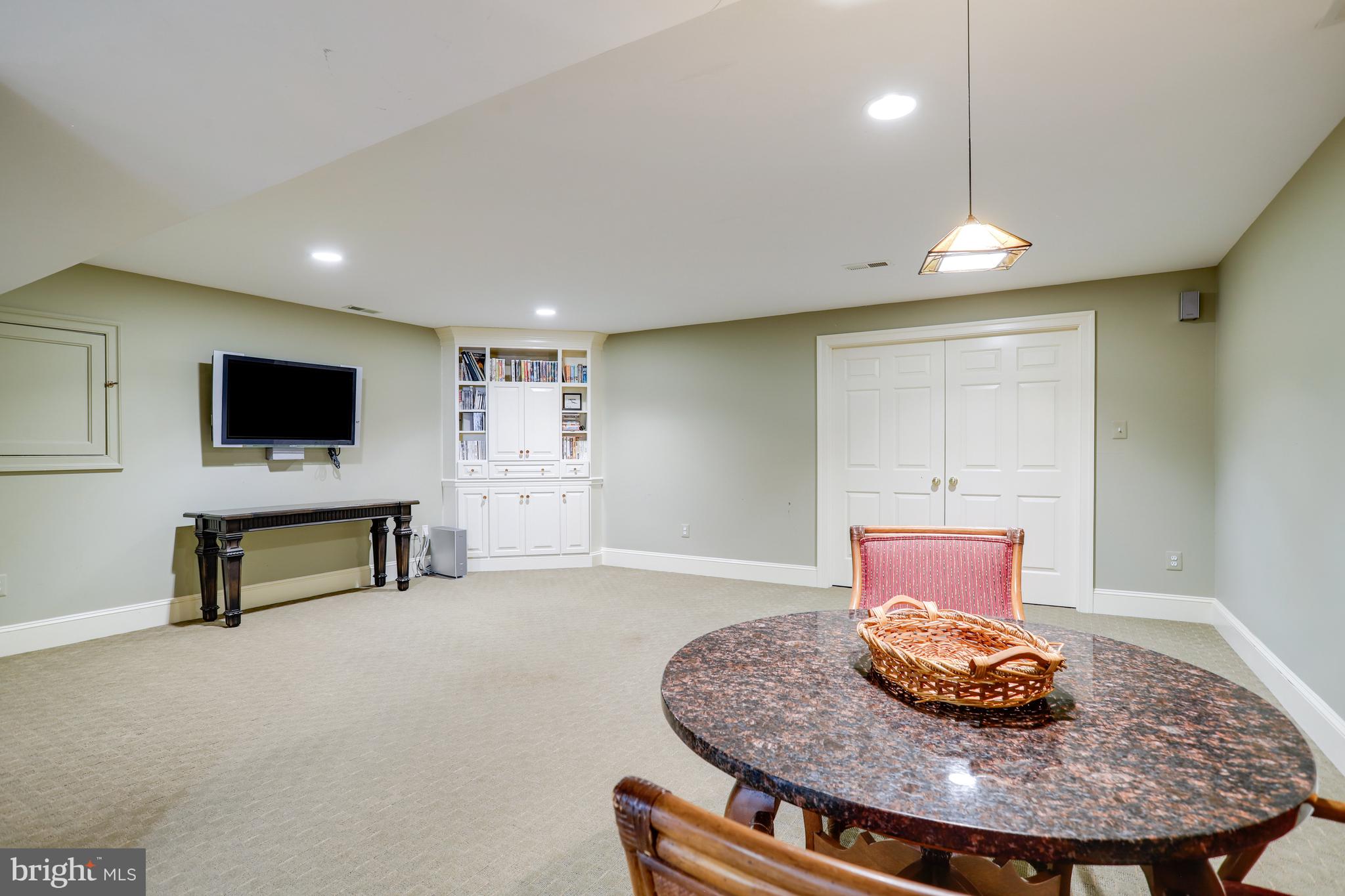5629 Newington Road Bethesda, MD 20816 - Photo 53 of 65 a living room with furniture and a flat screen tv