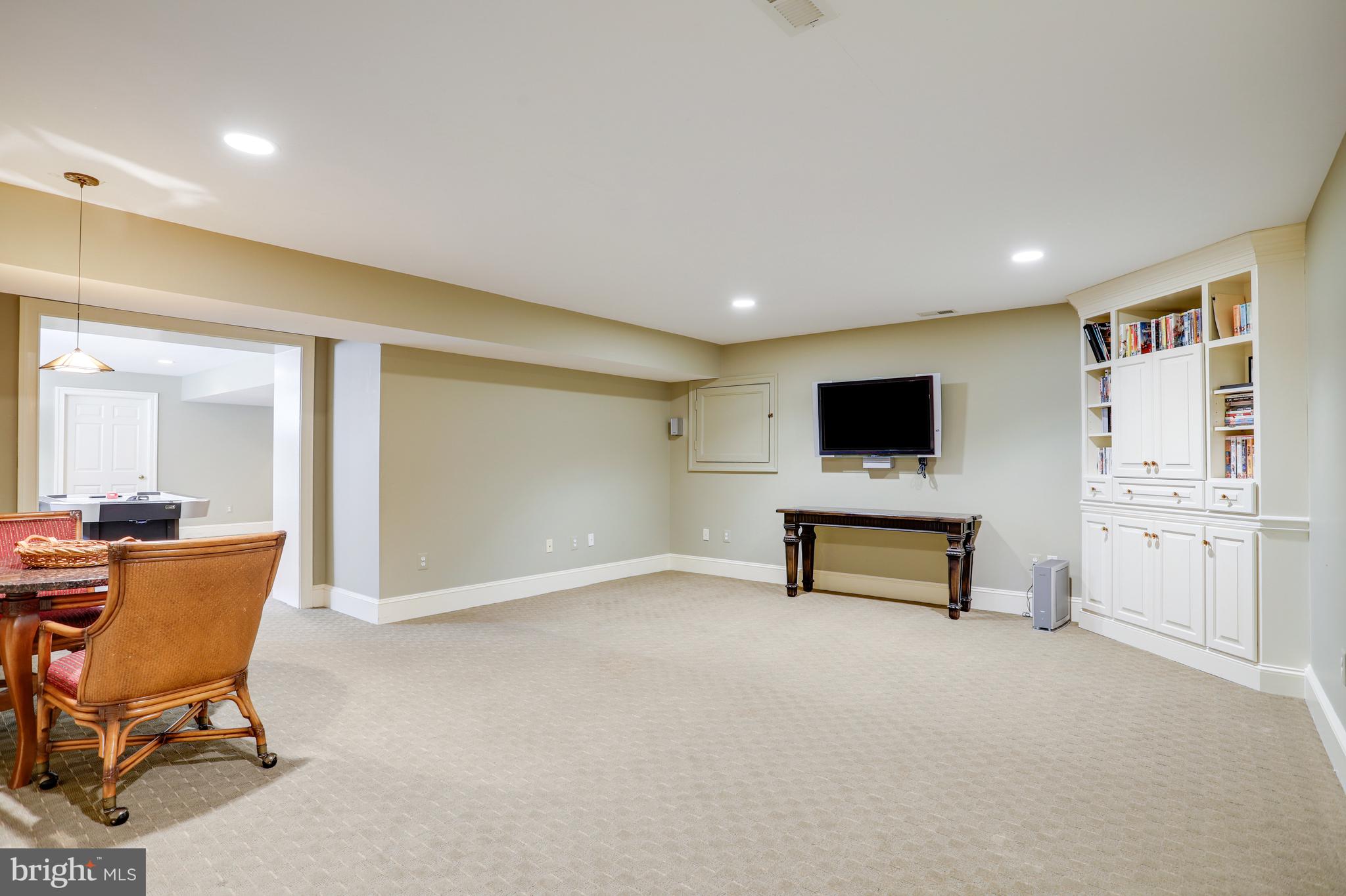 5629 Newington Road Bethesda, MD 20816 - Photo 54 of 65 a living room with furniture and a flat screen tv