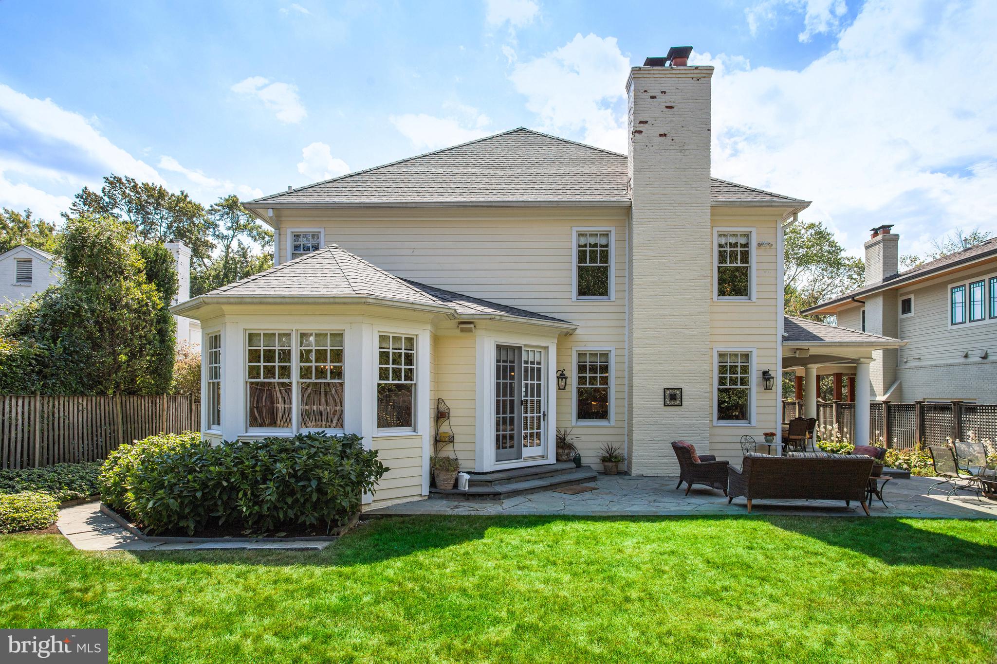 5629 Newington Road Bethesda, MD 20816 - Photo 55 of 65 a front view of a house with a yard and outdoor seating