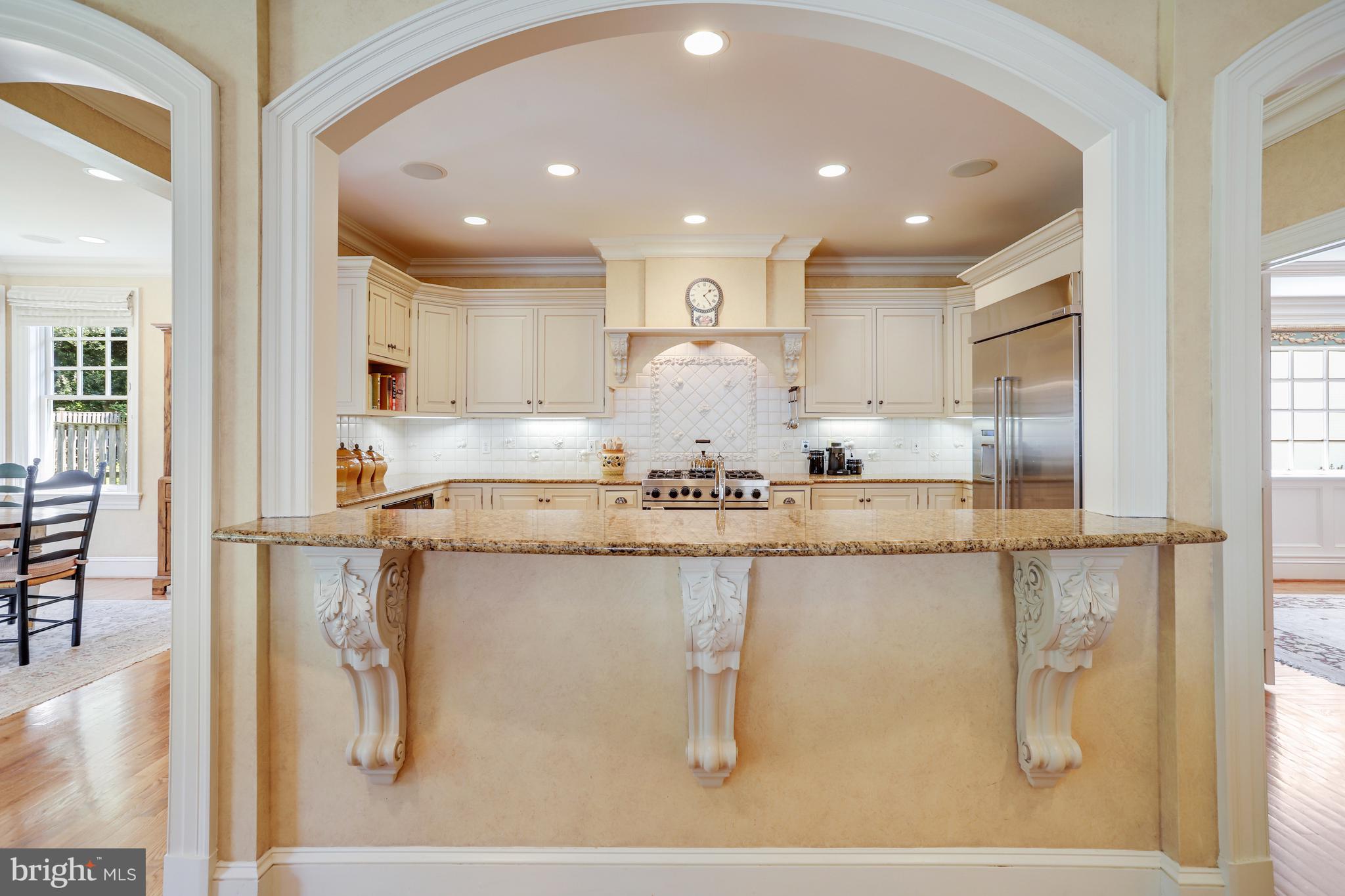 5629 Newington Road Bethesda, MD 20816 - Photo 8 of 65 a kitchen with kitchen island a counter top space and cabinets