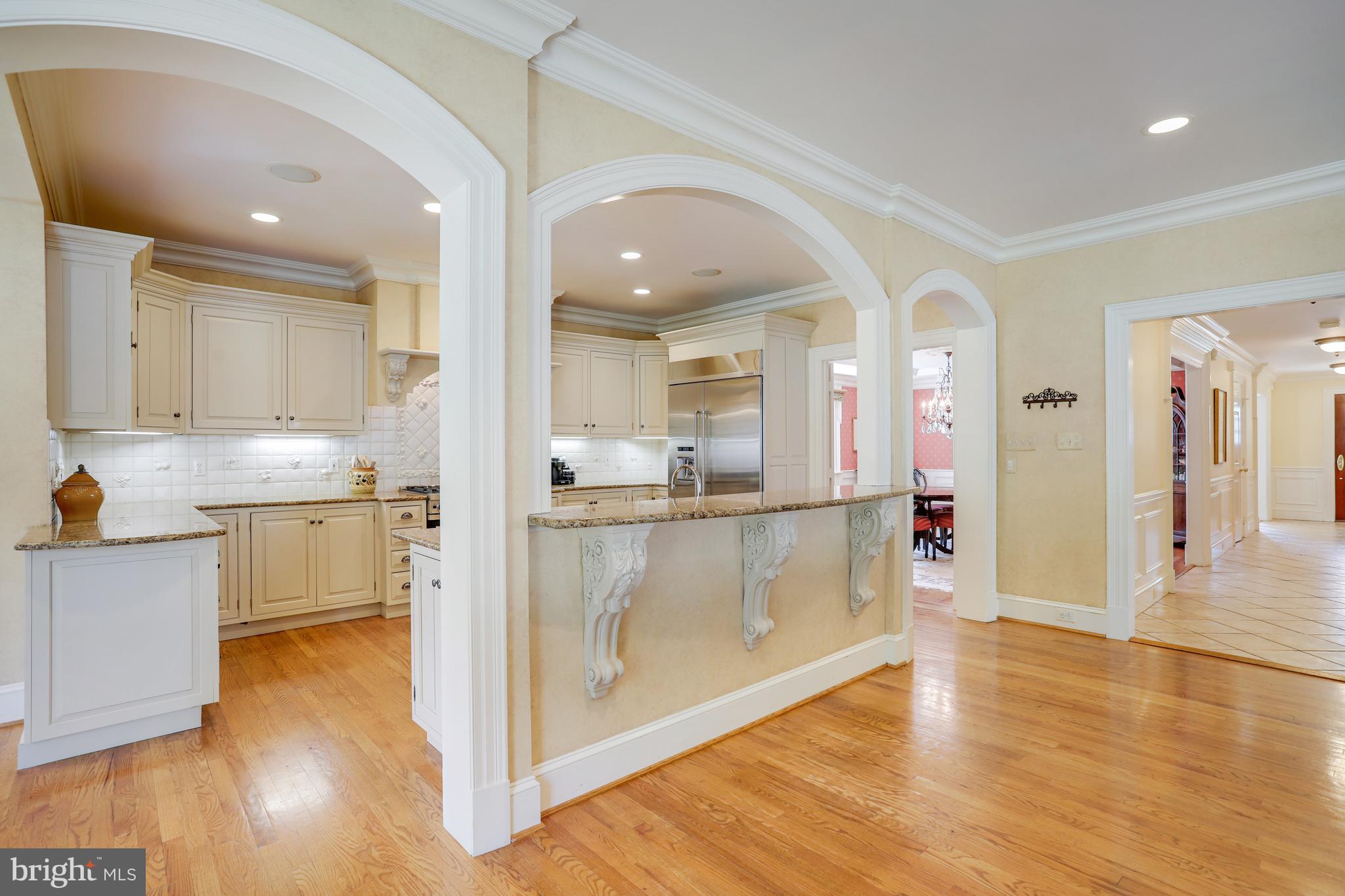 5629 Newington Road Bethesda, MD 20816 - Photo 9 of 65 a view of a kitchen with kitchen island a sink stainless steel appliances and cabinets