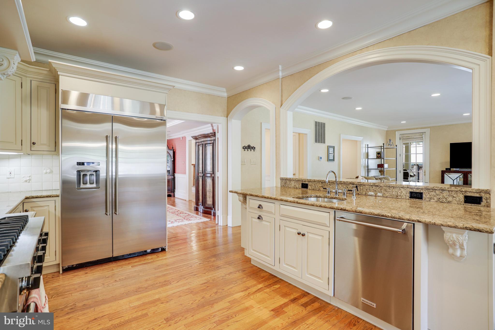 5629 Newington Road Bethesda, MD 20816 - Photo 10 of 65 a large kitchen with stainless steel appliances kitchen island a large counter top and a refrigerator