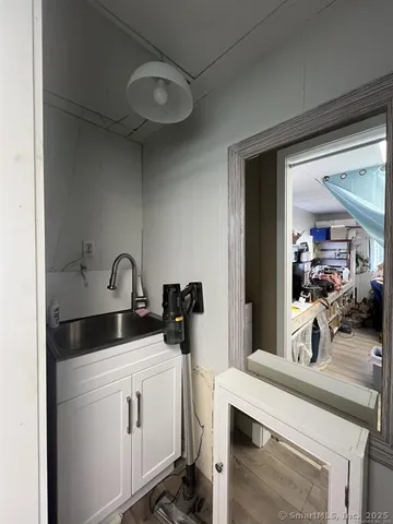 a kitchen with a sink a stove and cabinets