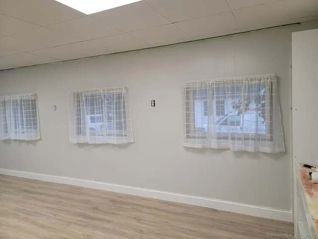 a view of a small space with wooden floor and windows