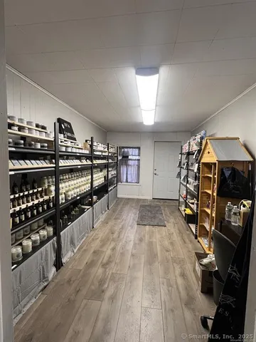 a view of a room with lots of wooden furniture and windows