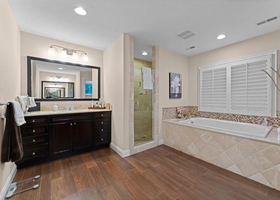 4700 Edgefield Road Bethesda, MD 20814 - Photo 15 of 29 a spacious bathroom with a granite countertop tub a double vanity sink and a mirror