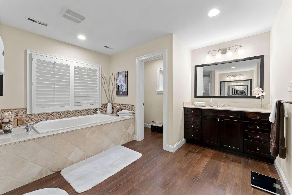 4700 Edgefield Road Bethesda, MD 20814 - Photo 16 of 29 a spacious bathroom with a tub sink and mirror