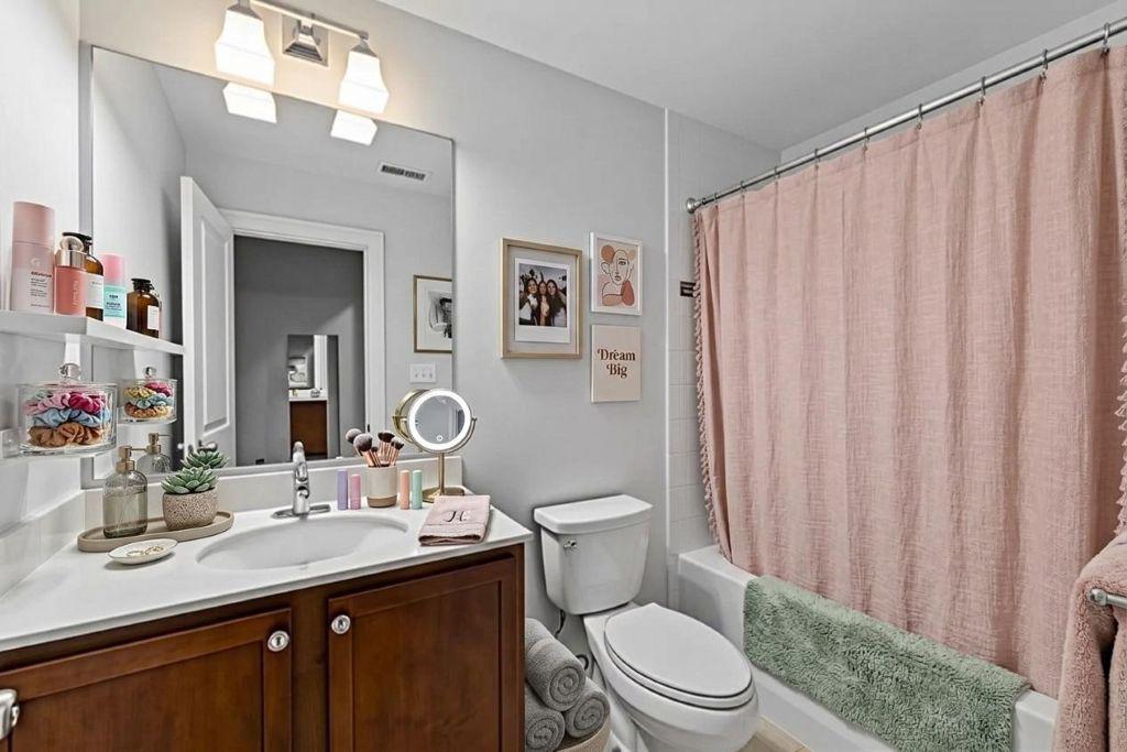 4700 Edgefield Road Bethesda, MD 20814 - Photo 18 of 29 a bathroom with a granite countertop sink toilet and a mirror