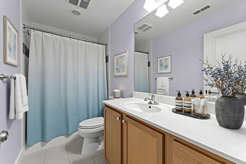 4700 Edgefield Road Bethesda, MD 20814 - Photo 20 of 29 a bathroom with a sink a toilet and shower curtain