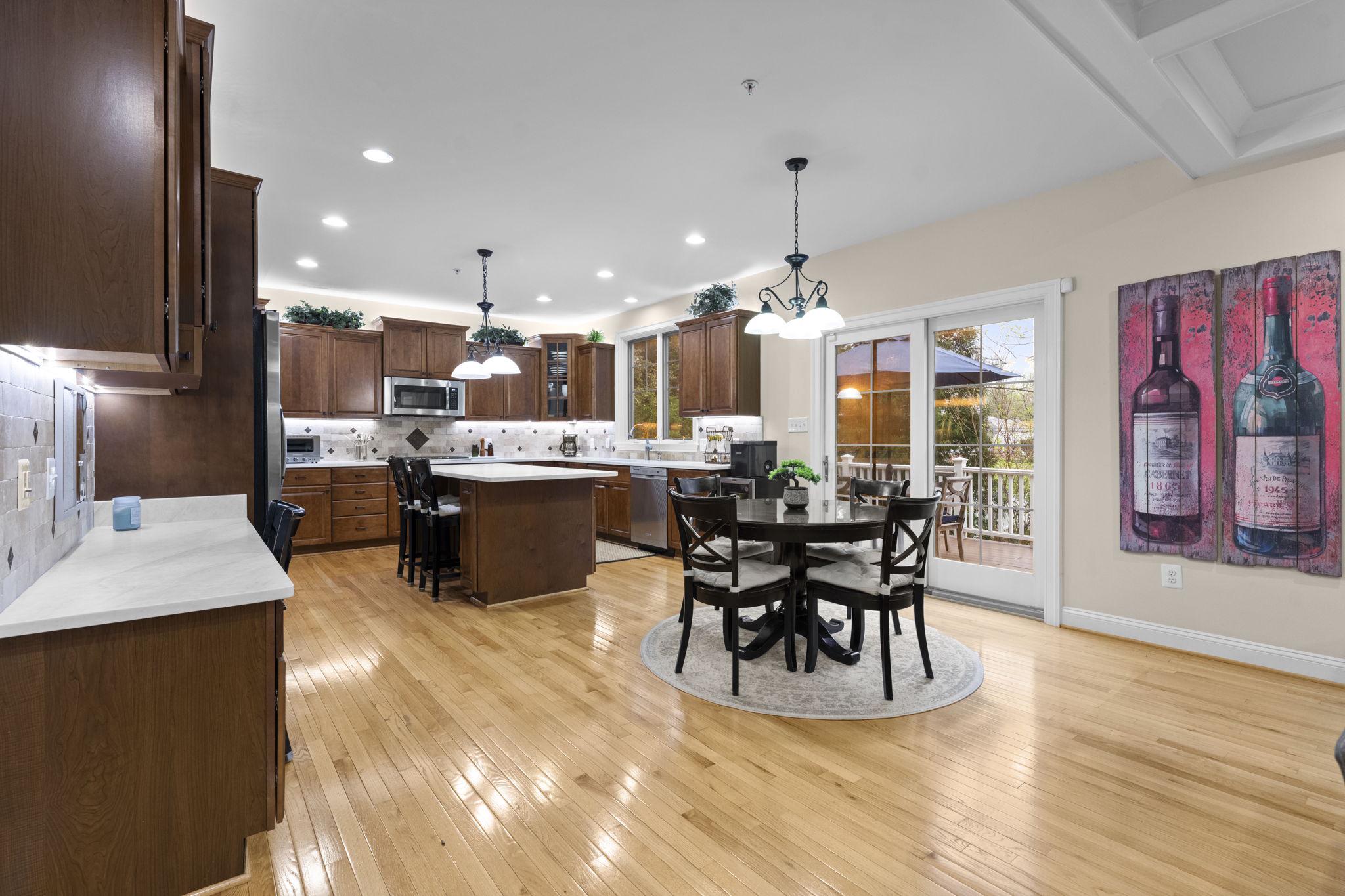 4700 Edgefield Road Bethesda, MD 20814 - Photo 7 of 29 a dining hall with stainless steel appliances kitchen island granite countertop a dining table chairs and granite counter tops