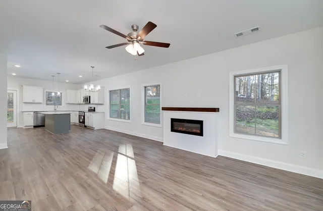 a view of a kitchen with a sink dishwasher and a fireplace