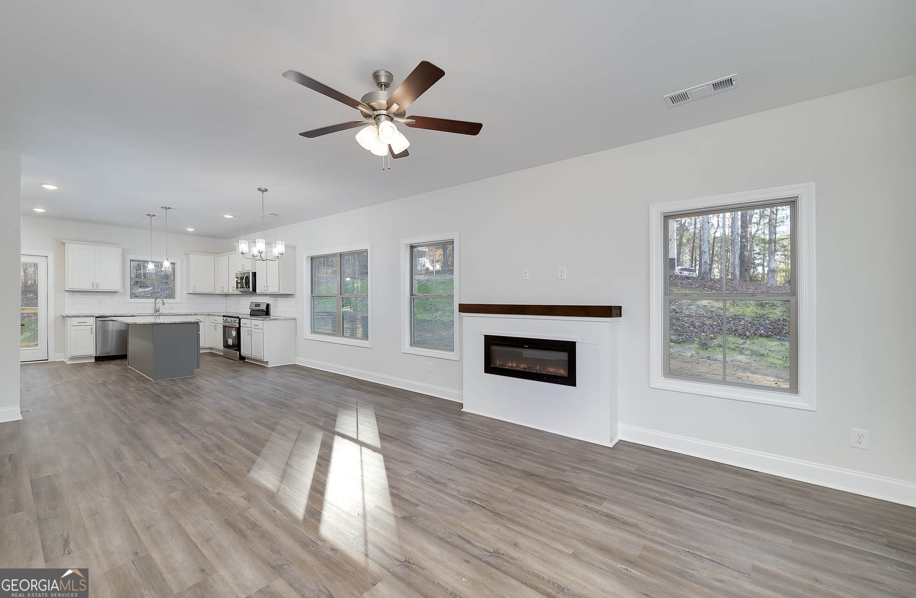 245 Pelican Circle Monticello, GA 31064 - Photo 11 of 37 a view of a kitchen with a sink dishwasher and a fireplace