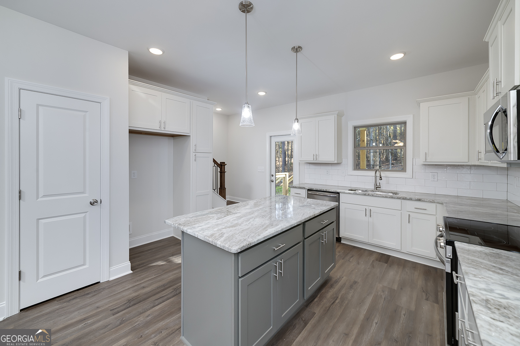 245 Pelican Circle Monticello, GA 31064 - Photo 15 of 37 a kitchen with a sink refrigerator and cabinets