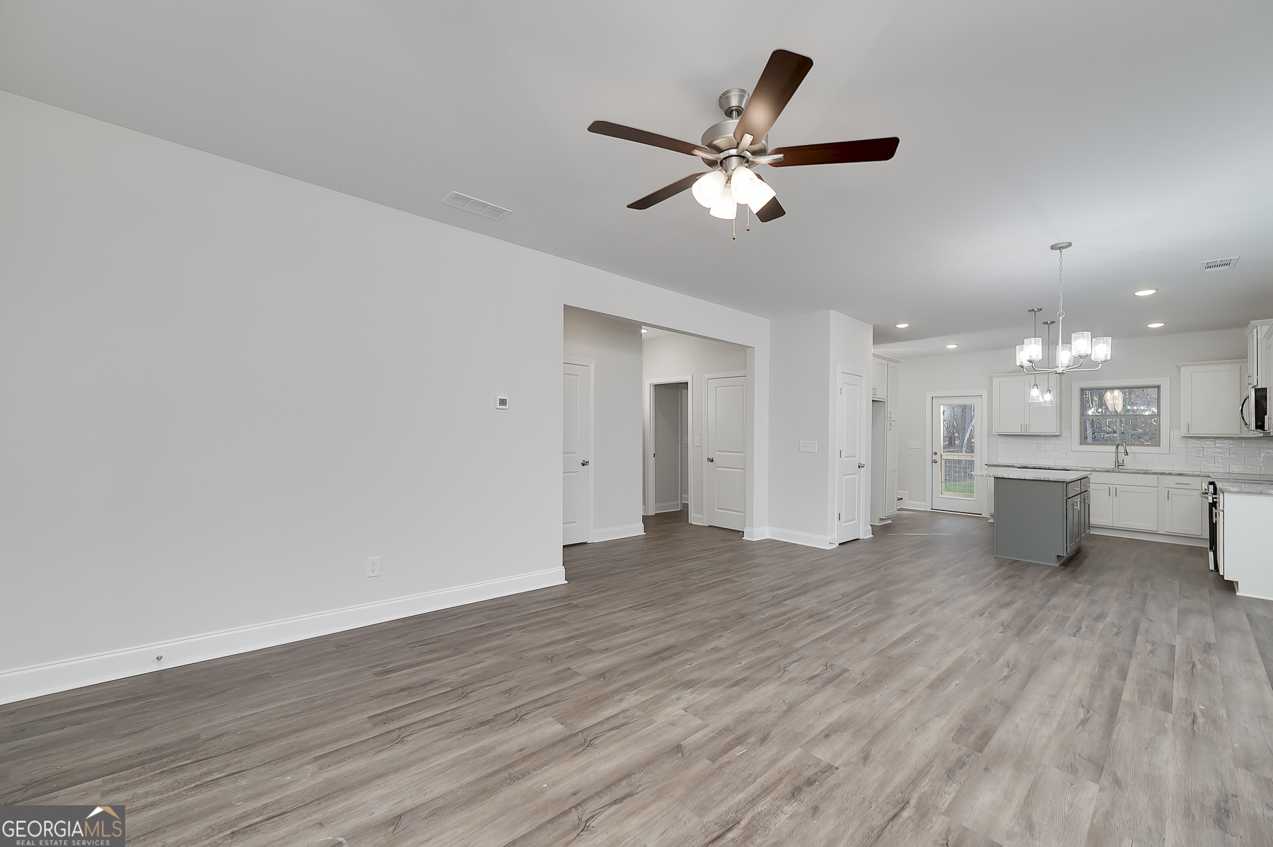 245 Pelican Circle Monticello, GA 31064 - Photo 18 of 37 a view of a kitchen with wooden floor and a sink