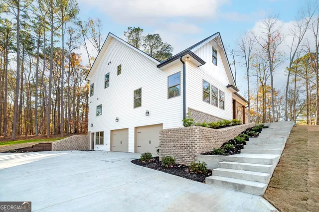 a view of a white house with a street