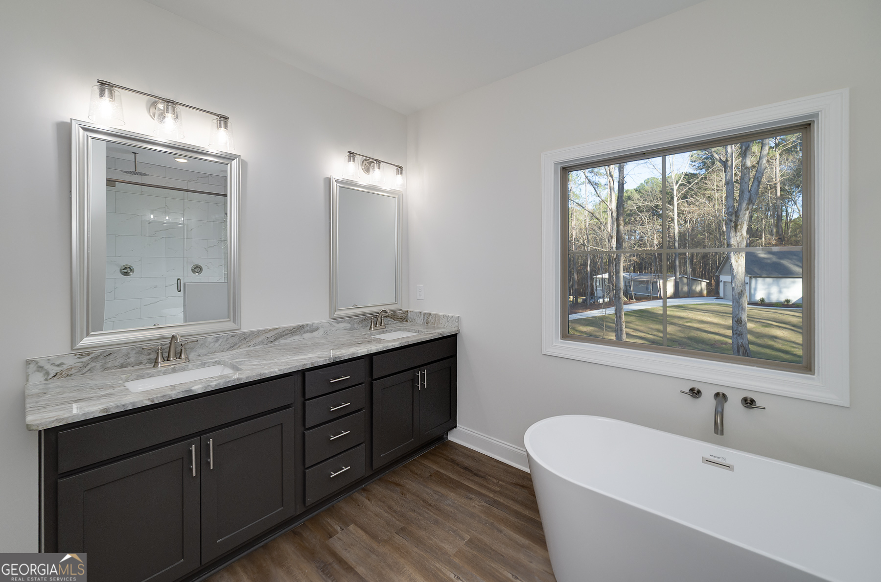 245 Pelican Circle Monticello, GA 31064 - Photo 23 of 37 a bathroom with a granite countertop tub a double vanity sink a mirror and a large window