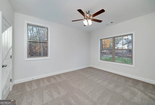 a bathroom with a granite countertop toilet sink and mirror