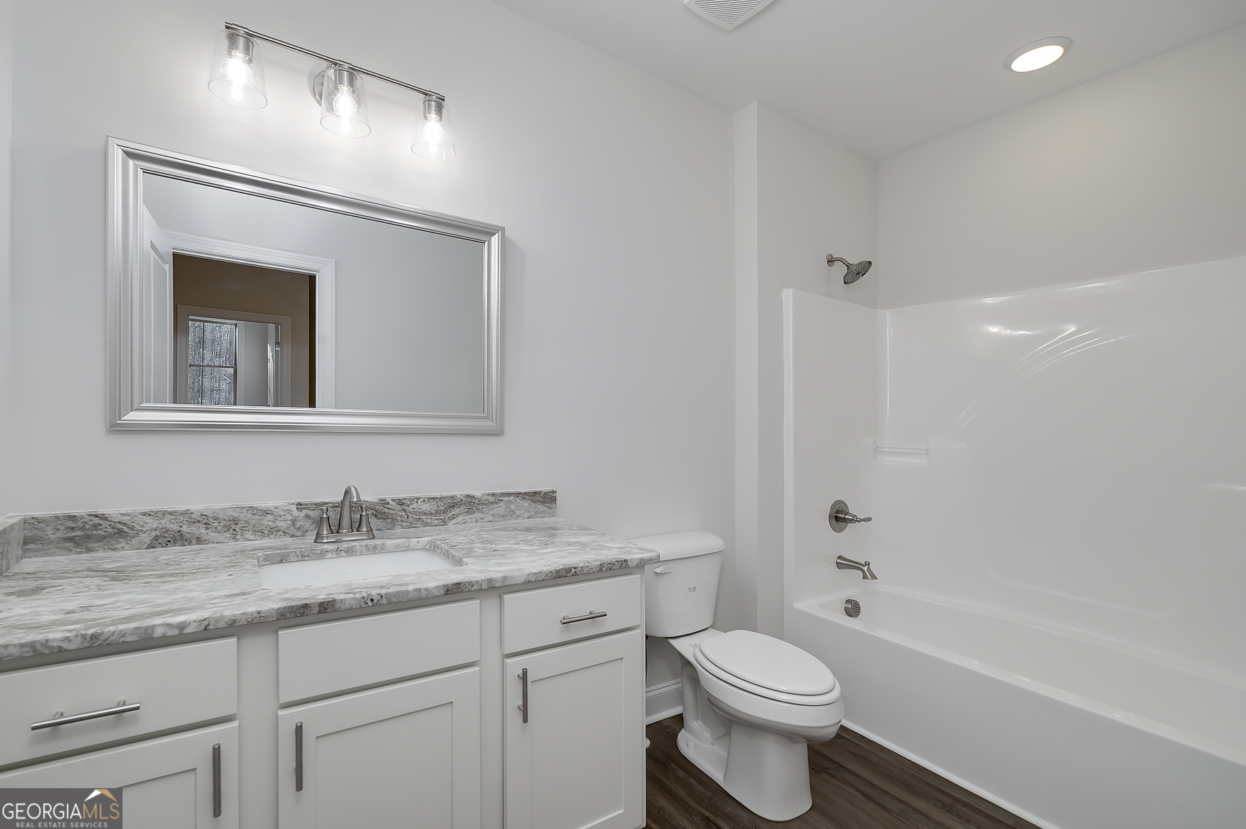 245 Pelican Circle Monticello, GA 31064 - Photo 31 of 37 a bathroom with a granite countertop toilet sink and mirror