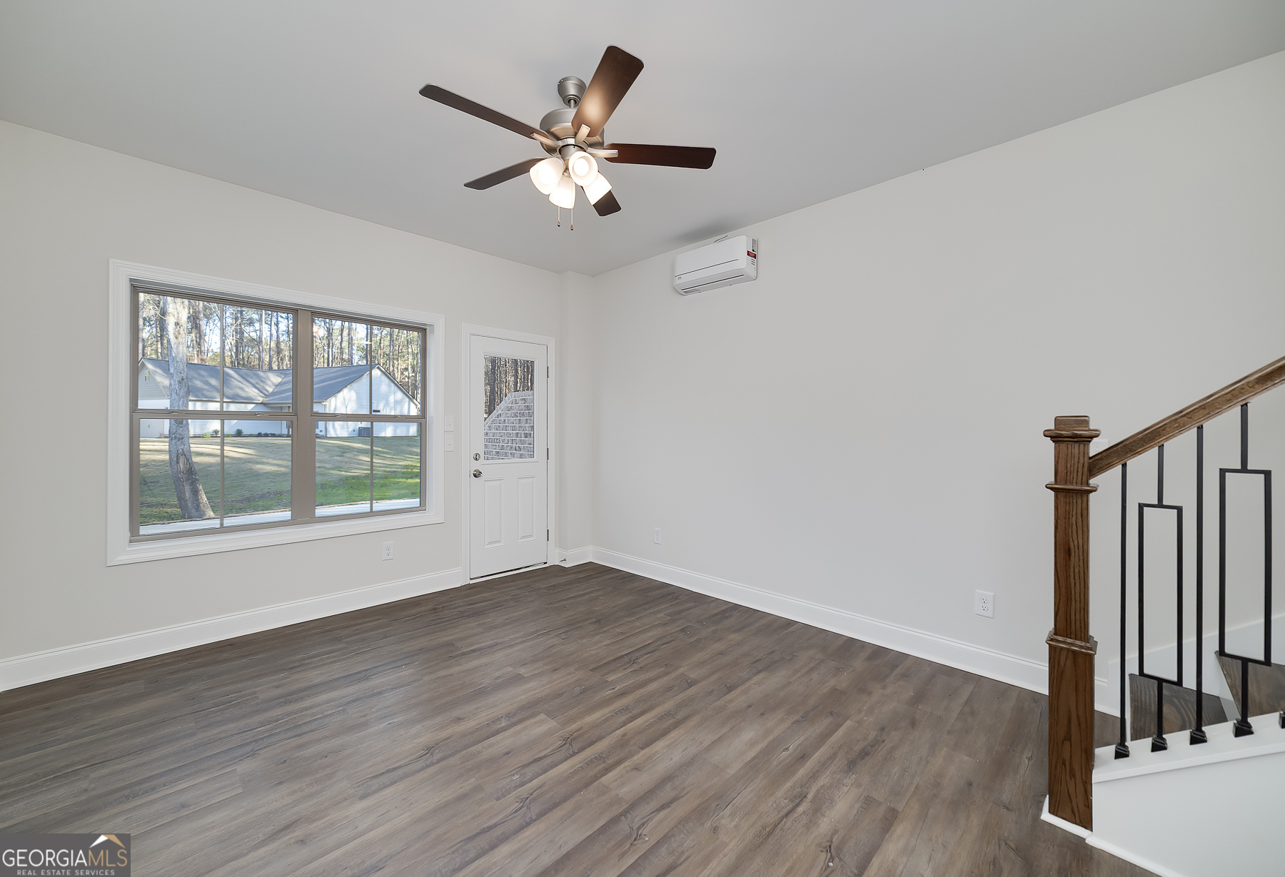 245 Pelican Circle Monticello, GA 31064 - Photo 32 of 37 a view of an empty room with wooden floor and a window