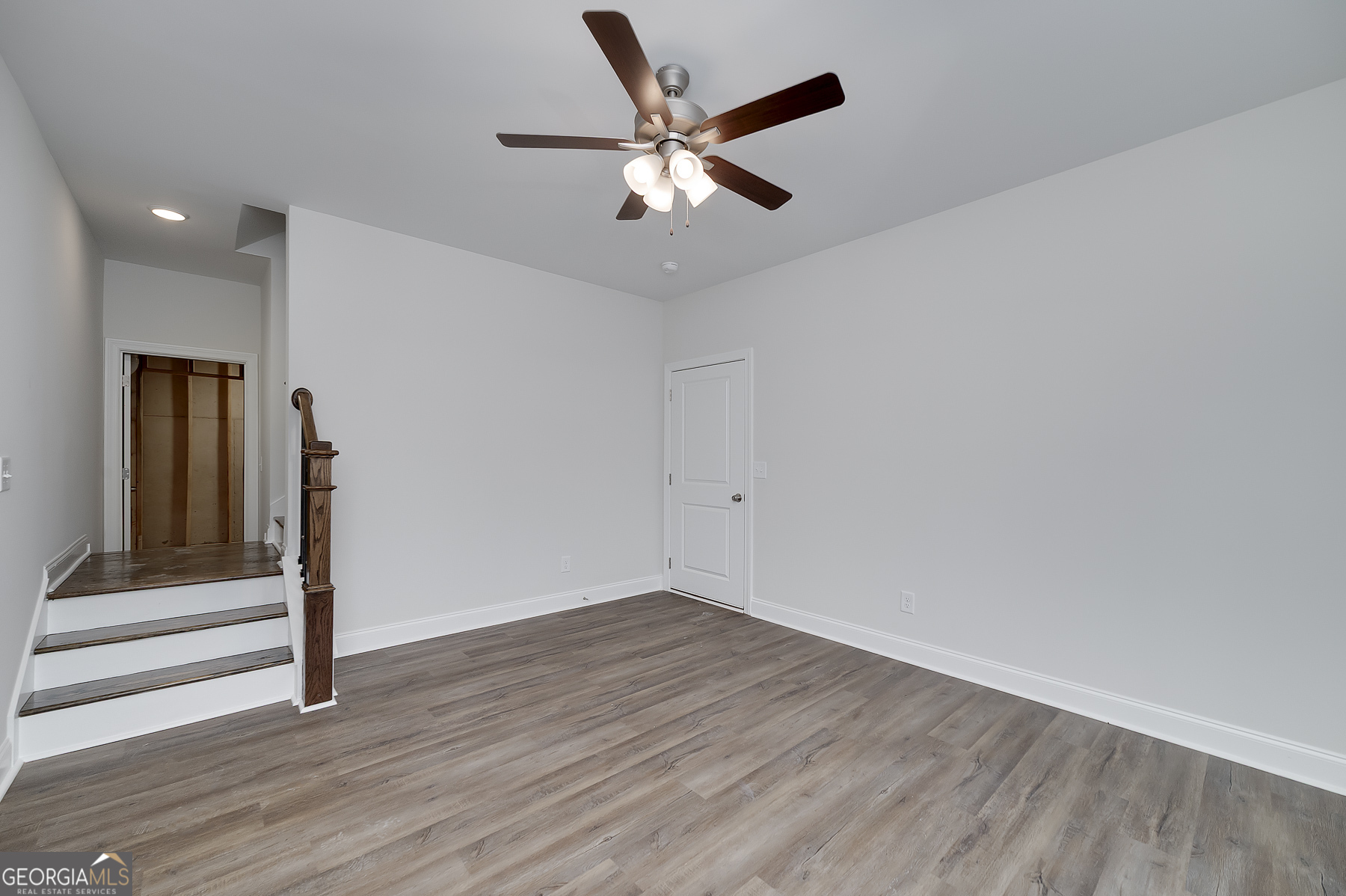 245 Pelican Circle Monticello, GA 31064 - Photo 33 of 37 an empty room with wooden floor and ceiling fan