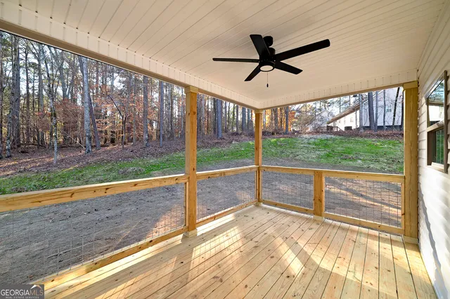 a view of a livingroom with furniture ceiling fan and hardwood floor