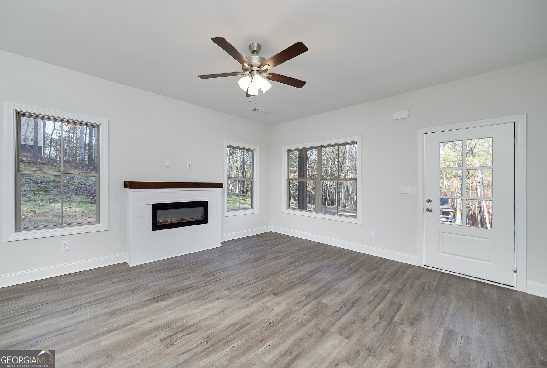 245 Pelican Circle Monticello, GA 31064 - Photo 10 of 37 a view of an empty room with wooden floor and a window