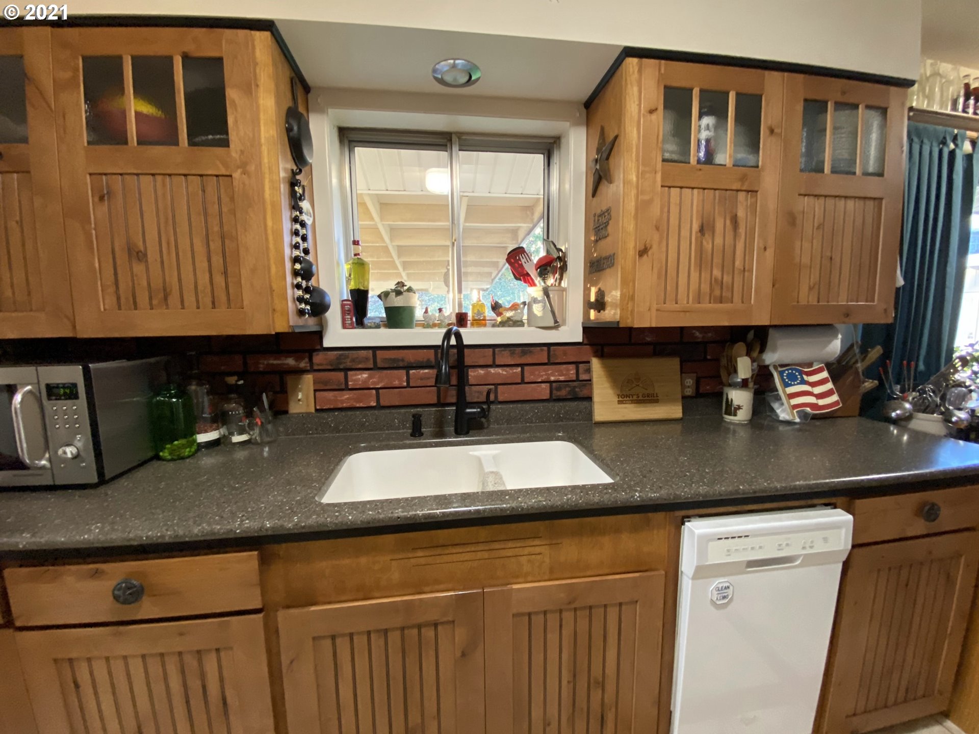 3227 Southwest Isaac Avenue Pendleton, OR 97801 - Photo 9 of 30 a kitchen with sink a window and cabinets
