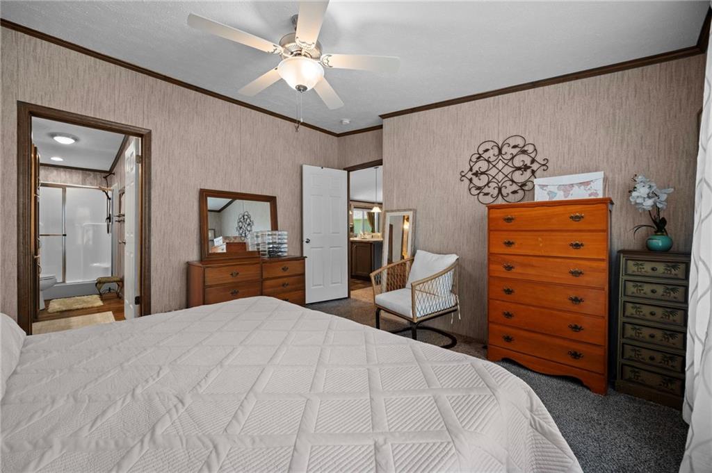 73 South Summit Road, Unit 510 Greenville, PA 16125 - Photo 17 of 33 a bedroom with a bed and a chandelier