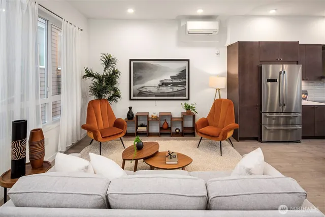 a living room with furniture a couch and paintings on the wall